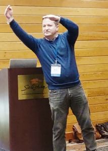 RJ Gillespie animatedly answering a question during a presentation